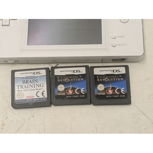 1519 - A white Nintendo DS Console With Charger and 4 Games - Working