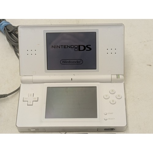 1519 - A white Nintendo DS Console With Charger and 4 Games - Working