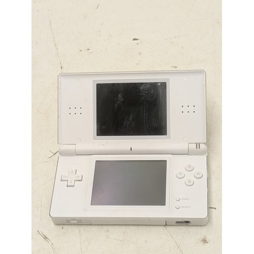 1519 - A white Nintendo DS Console With Charger and 4 Games - Working