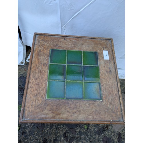 497 - An early 20th century oak table with tiled top