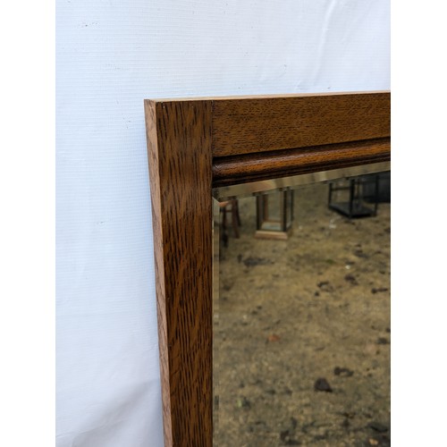 464 - A tall bevelled edge wall mirror