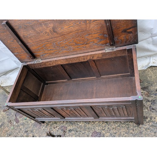 498 - An antique style oak storage chest