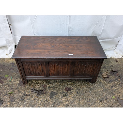 498 - An antique style oak storage chest