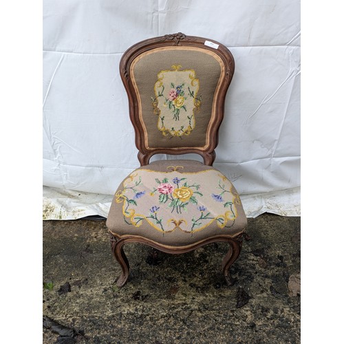 494 - A antique oak lounge chair with floral engravings and floral upholstery