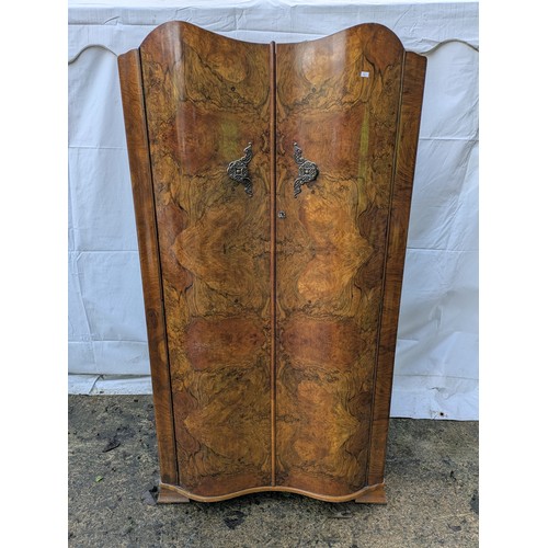 492 - An oak and walnut veneered gentleman's wardrobe with bowed front and internal compartments