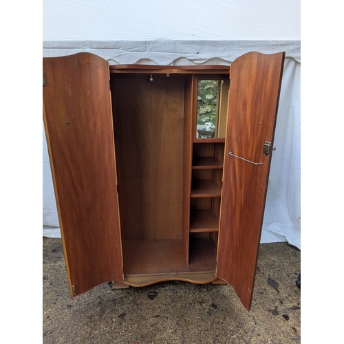 492 - An oak and walnut veneered gentleman's wardrobe with bowed front and internal compartments