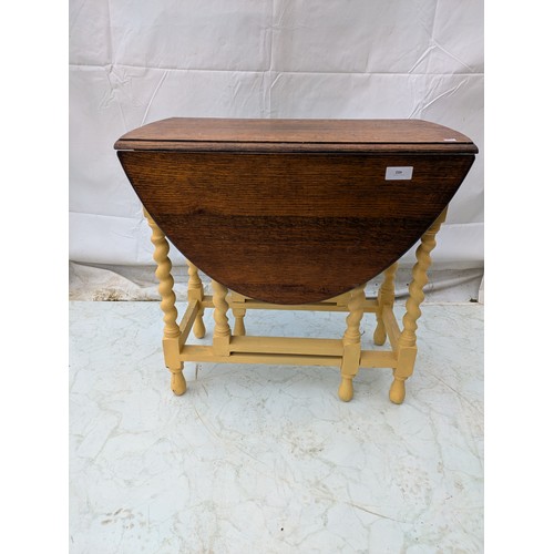 482 - An early 20th century oak drop leaf table with painted barley twist legs