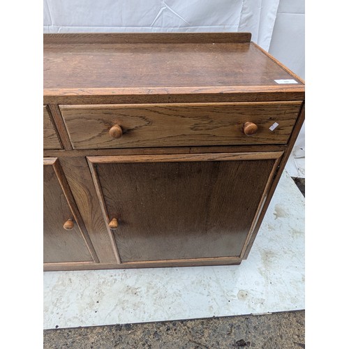 466 - An oak storage cabinet with 2 drawers and 2 cabinet spaces - mid century?