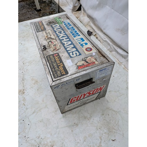 5 - A vintage aluminium vented storage trunk with a selection of automotive stickers