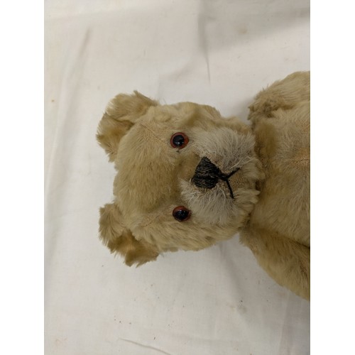 831 - An early 19th century straw stuffed bear with moveable limbs