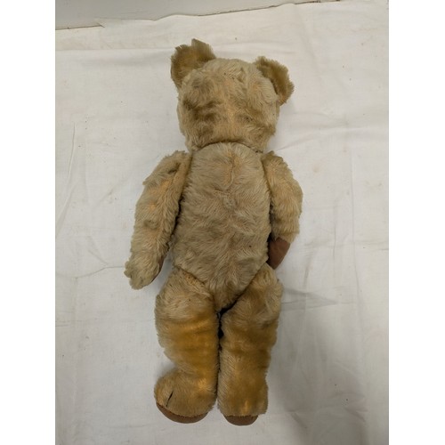 831 - An early 19th century straw stuffed bear with moveable limbs