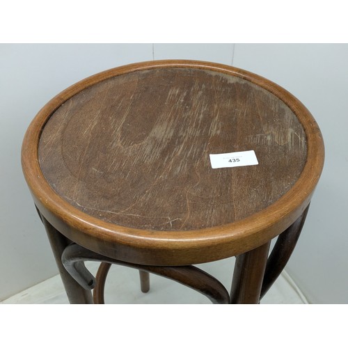 435 - A vintage bent wood stool with ornately engraved top