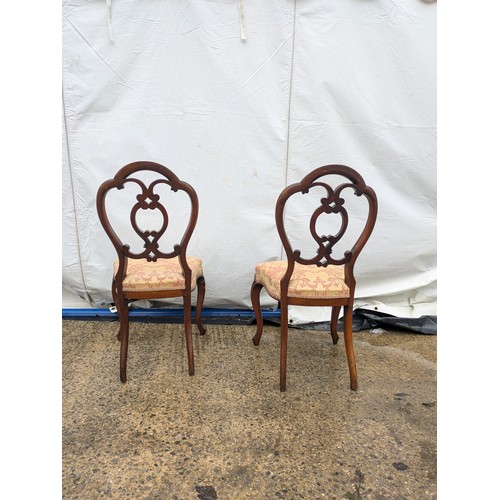 450 - A pair of mid 19th century mahogany dining chairs with a red and cream floral upholstered base and a... 