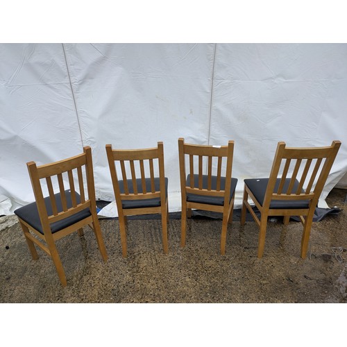 403 - A set of 4 oak dining chairs with black leather seat bases