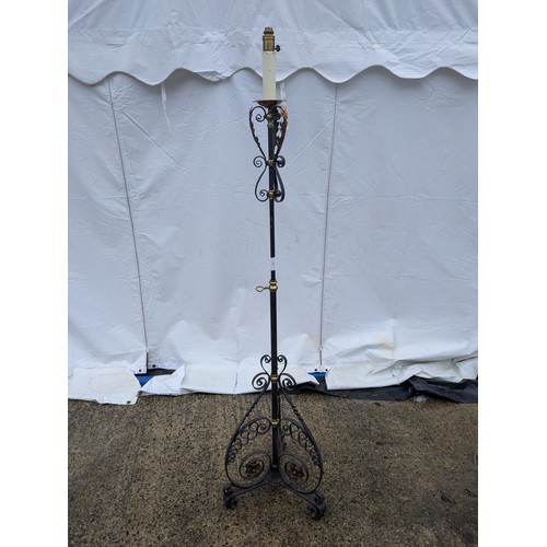 410 - A Stylish wrought iron, brass and copper lamp stand with a candle effect top and flared tripod base