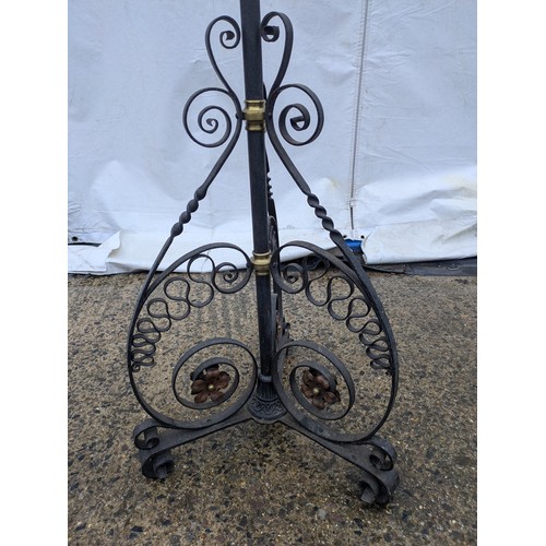 410 - A Stylish wrought iron, brass and copper lamp stand with a candle effect top and flared tripod base