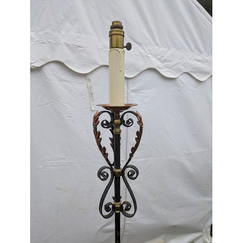 410 - A Stylish wrought iron, brass and copper lamp stand with a candle effect top and flared tripod base