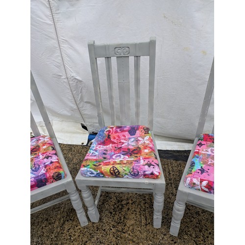 418 - A Set of 4 painted pine dining chairs with floral seat bases