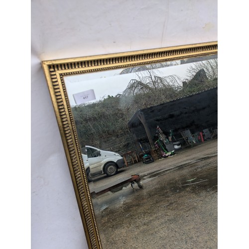 417 - A large bevelled edged mirror in a gilded frame