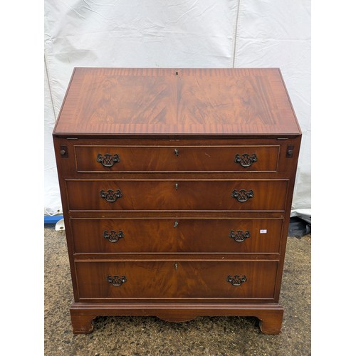 402 - An antique mahogany bureau with 2 keys and 4 drawers