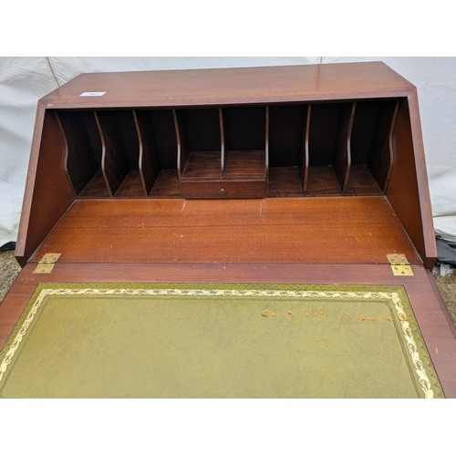 402 - An antique mahogany bureau with 2 keys and 4 drawers