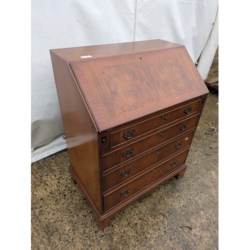 402 - An antique mahogany bureau with 2 keys and 4 drawers