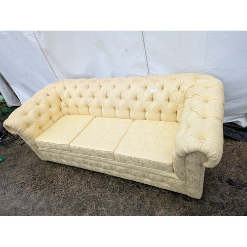 451 - A cream floral pattern upholstered 3 seat chesterfield sofa