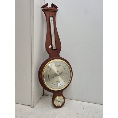 801 - A wall mounted brass clock and thermometer hygrometer