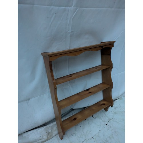 521 - A small wall mounted pine shelving unit