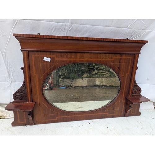 484 - A late 19th century mahogany veneered fireplace mirror with bevelled edge and walnut inlays