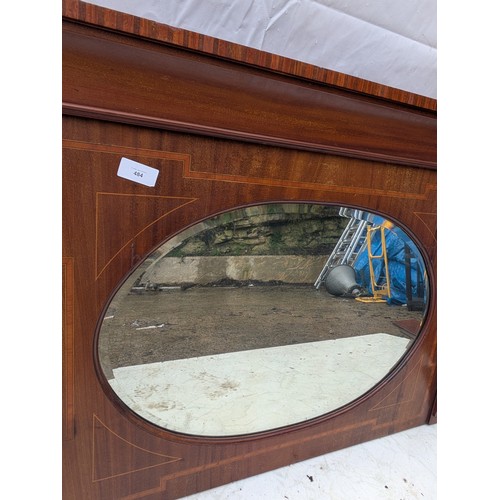 484 - A late 19th century mahogany veneered fireplace mirror with bevelled edge and walnut inlays