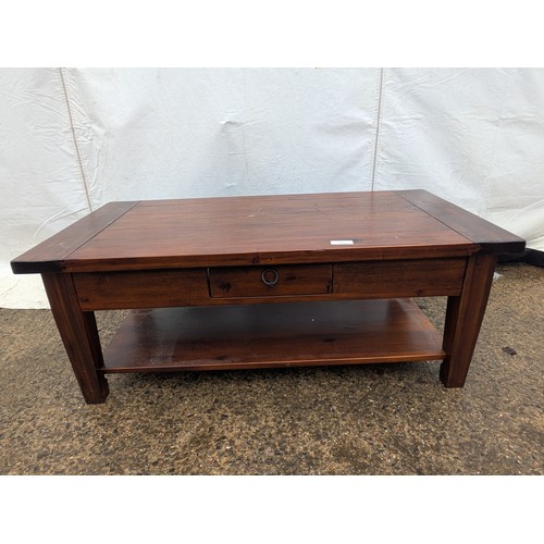 486 - A mahogany 7 plank coffee table with an underlying storage area