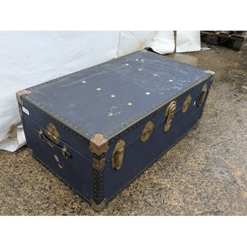 455 - A vintage canvas overpond storage trunk in blue