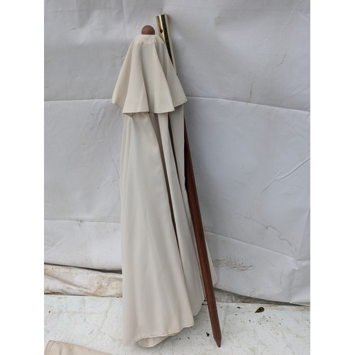 14 - A cream stainless steel and oak parasol in carry bag