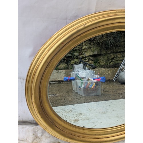 467 - A oval mirror in a gilt floral frame