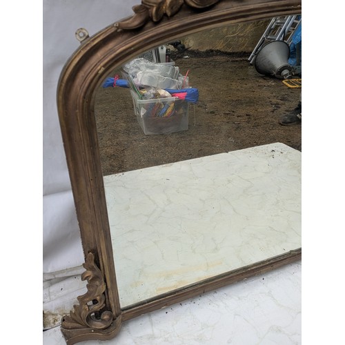 852 - A Lovely early 20th century Wall mounted mirror in an ornate gilded and bevelled frame