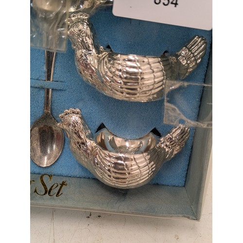 854 - A Queen Anne silver plated egg cup and spoon set in original packaging