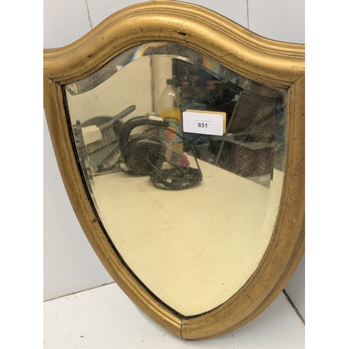 851 - A Vintage shield mirror with a bevelled edge and gilded frame