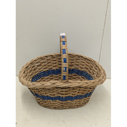 855 - A wicker hamper basket with blue accents