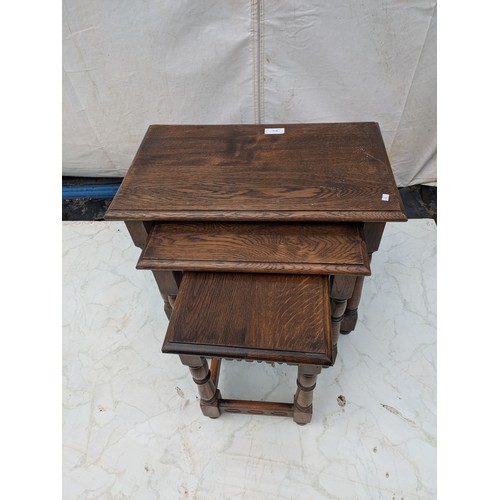 613 - A nest of tables - stained oak - early 20th Century