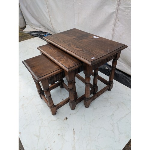 613 - A nest of tables - stained oak - early 20th Century