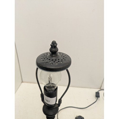 1061 - An Antique Styled Cast Iron Lamp