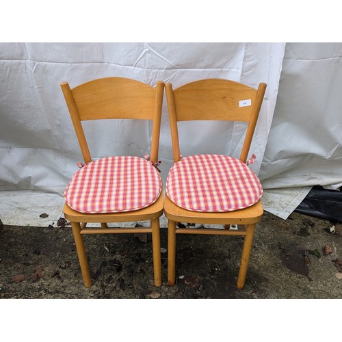 653 - A pair of retro style dining chairs with cushions