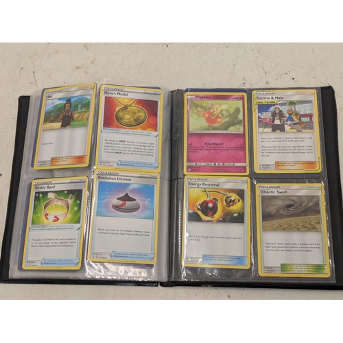 1977 - A binder containing various pokémon cards