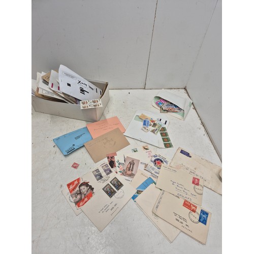 240 - A shoe box of first day covers and envelopes of stamps