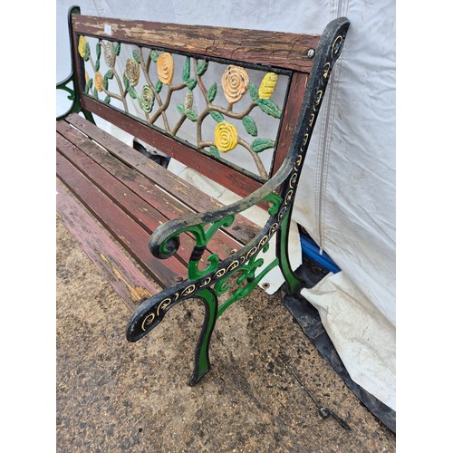 215 - A garden bench with floral effects cast iron back and ends