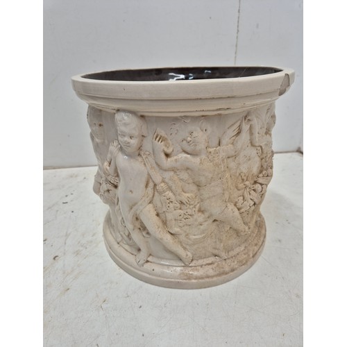 36 - An interesting ceramic planter with depictions of cherubs