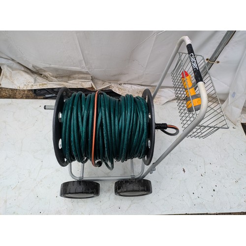 21 - A claber gardenhose on a heavy duty trolley