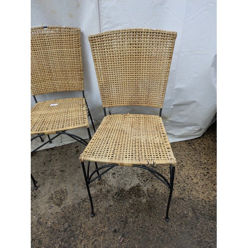 11 - A set of four outdoor wicker chairs with metal frames