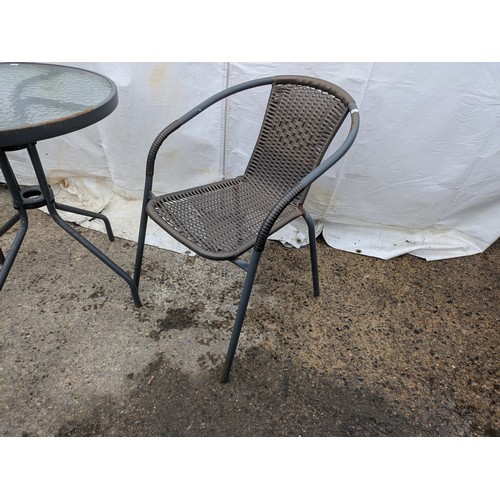 8 - A steel and glass topped bistro table with wicker seat bases